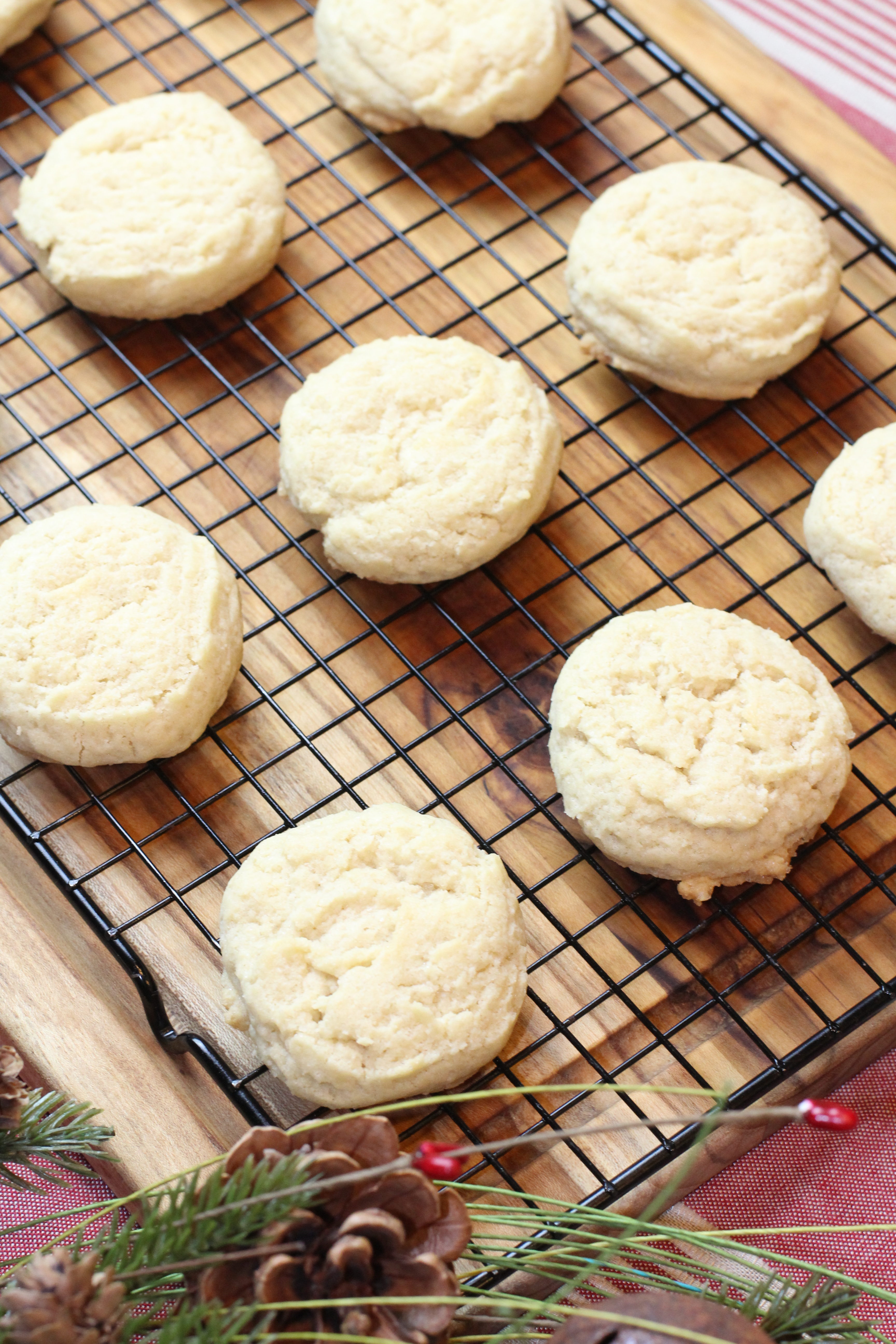 A cooling rack lined with freshly baked sugar shortbread cookies hot from the oven.