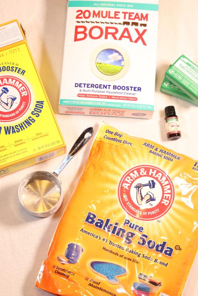 All the products needed to make homemade laundry soap resting neatly on a table.