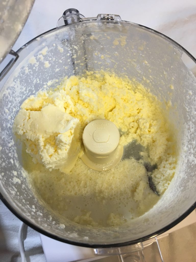 The heavy whipping cream and buttermilk are beginning to separate after being processed for 4 minutes. Making food processor butter is really simple and fast. The heavy whipping cream is a beautiful golden yellow.