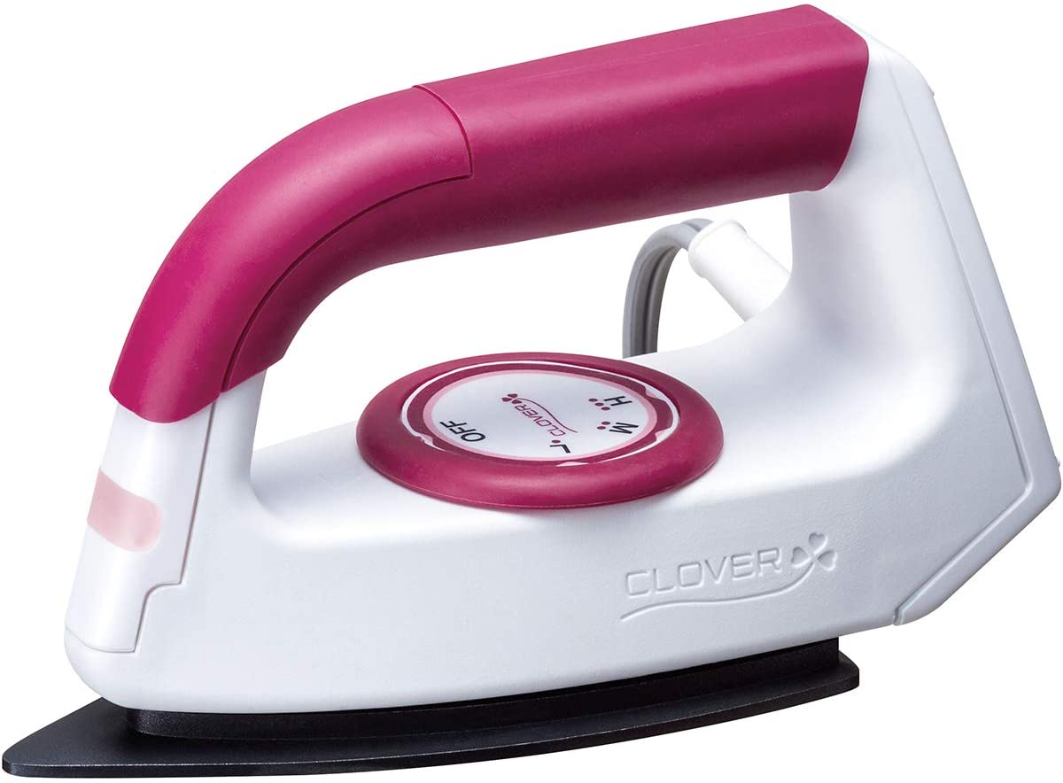 A close up picture of the clover wedge iron with a large round dial to adjust the heat setting. The mini iron is white and bright fuchsia colored.