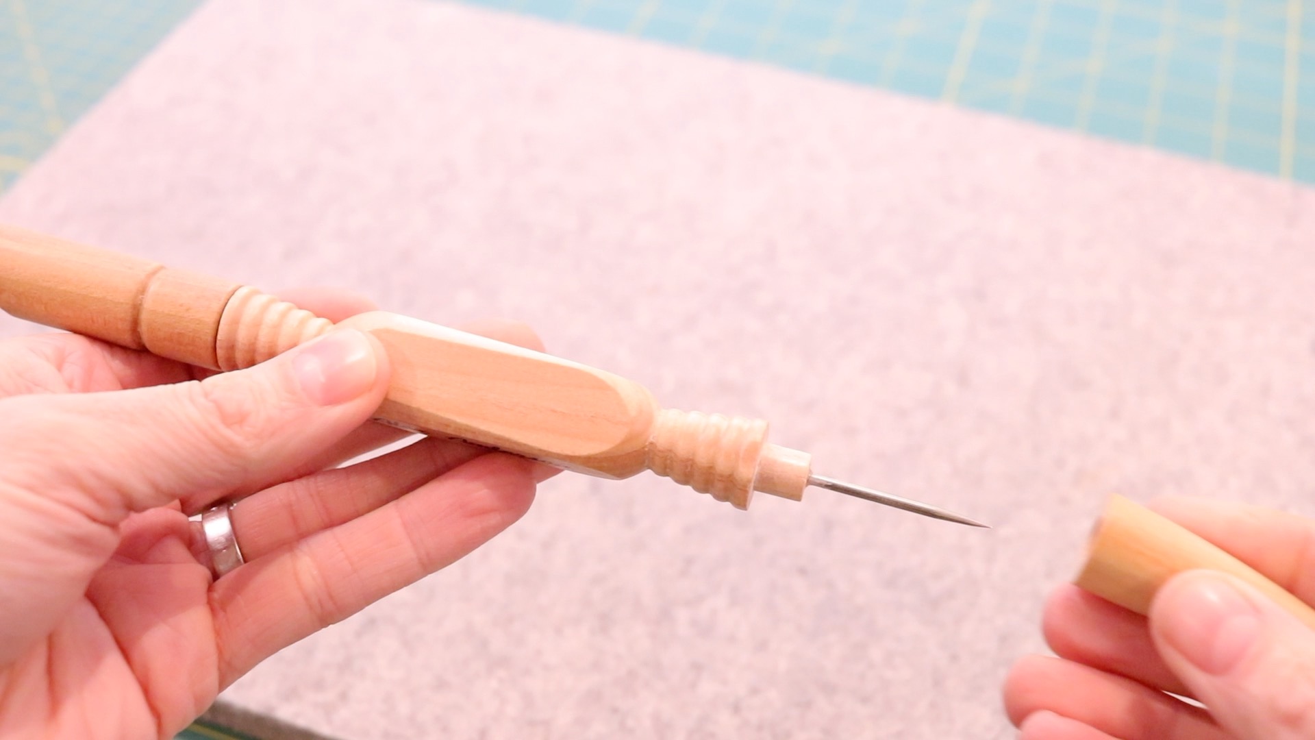 Wooden 4-in-1 sewing tool with a very sharp, metal awl hidden under a wooden top. 