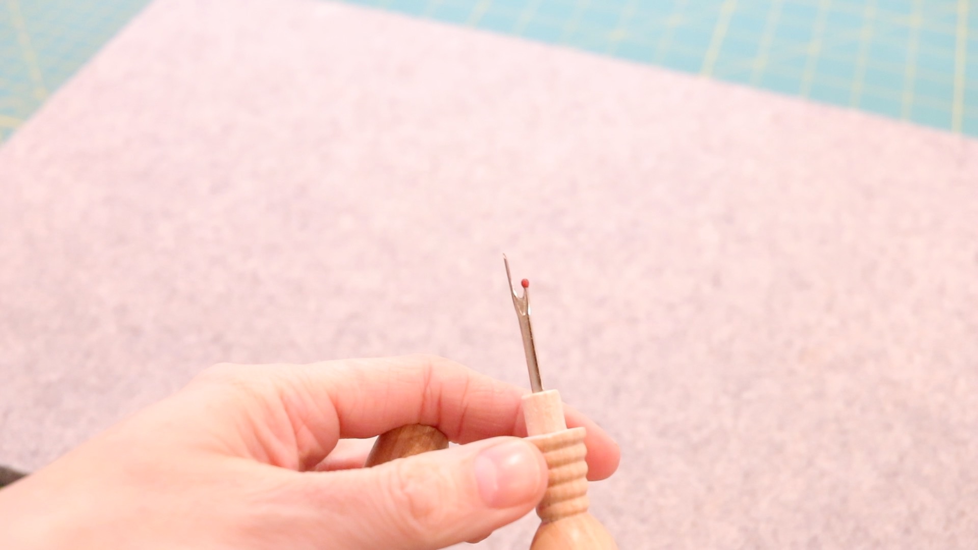 Metal seam ripper on the 4-in-1 tool. The seam ripper is on the opposite end, also hidden under a wooden removable cap.