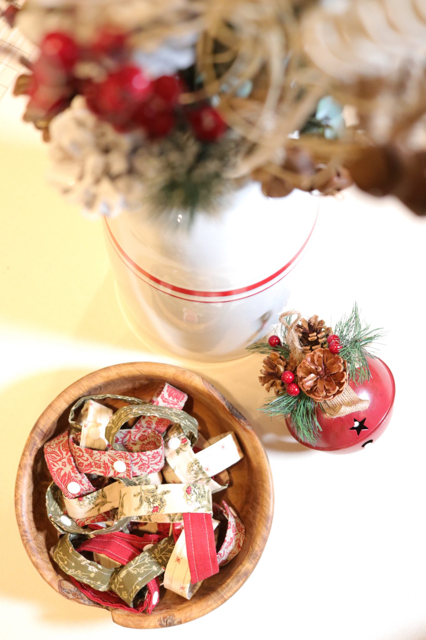 A beautiful handmade fabric Advent chain full of bright Christmas printed fabrics in shades of red, green and ivory. 