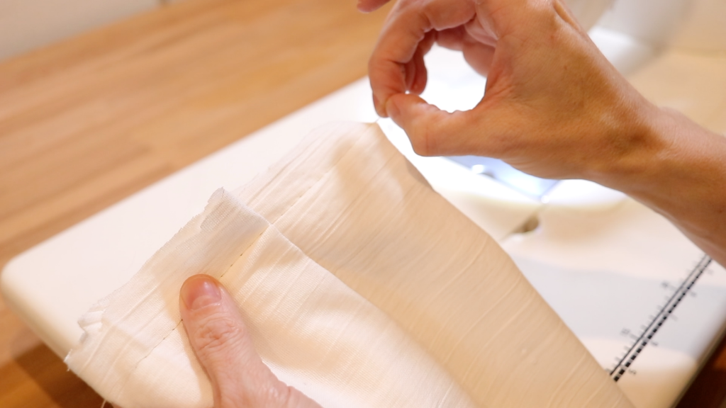 A newly gathered piece of white gauze fabric for the kitchen scarf sewing project.