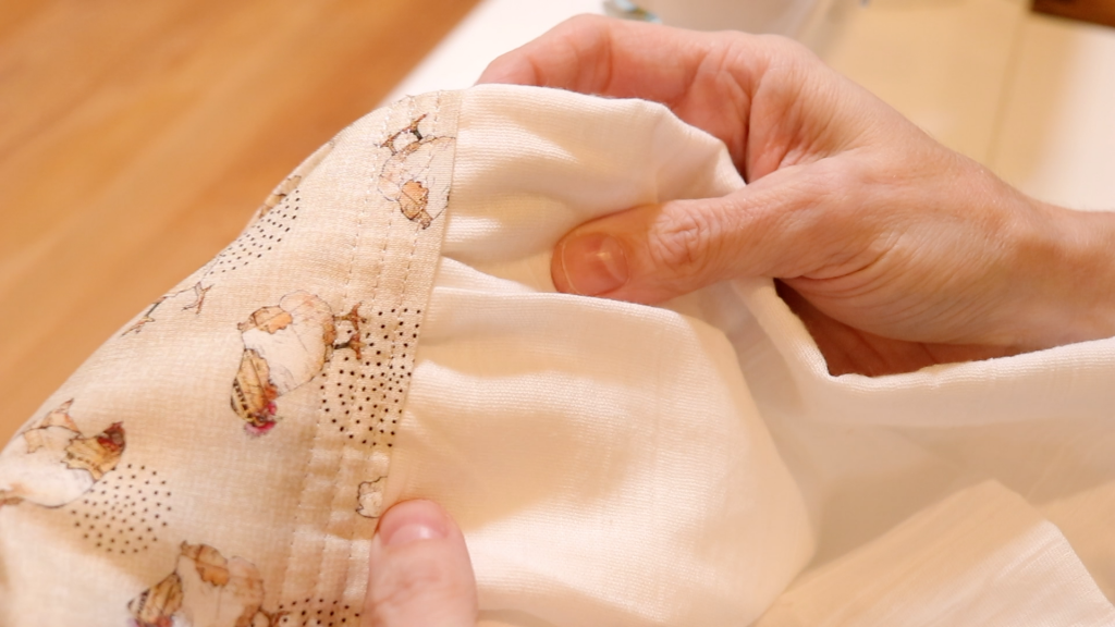 Extra seam stitches are sewn for reinforcement on the homemade scarf.