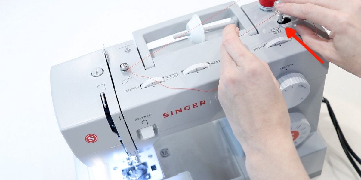 engaging the bobbin winding function on the top sewing machine