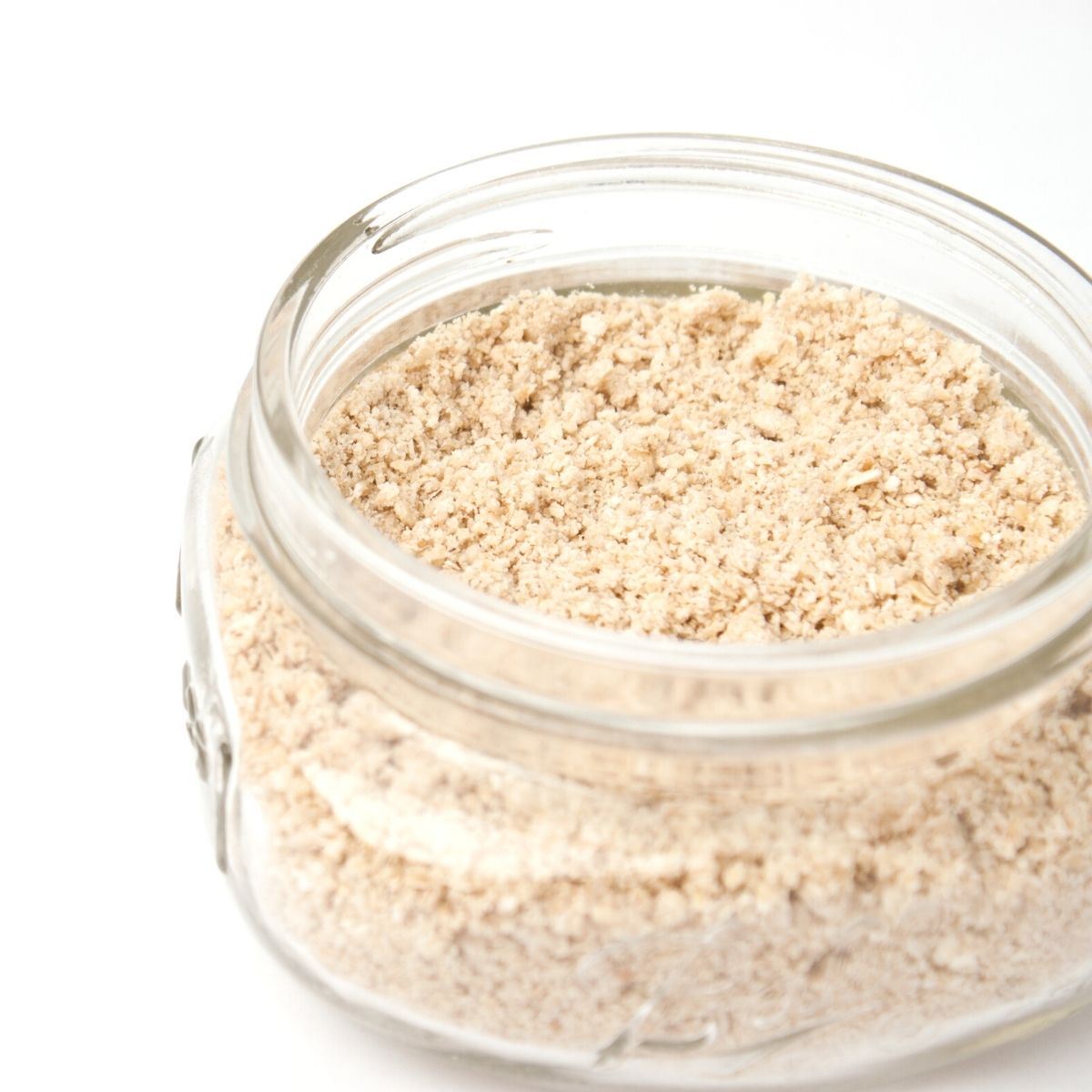 a small glass jar filled almost to the top with colloidal oatmeal powder. 