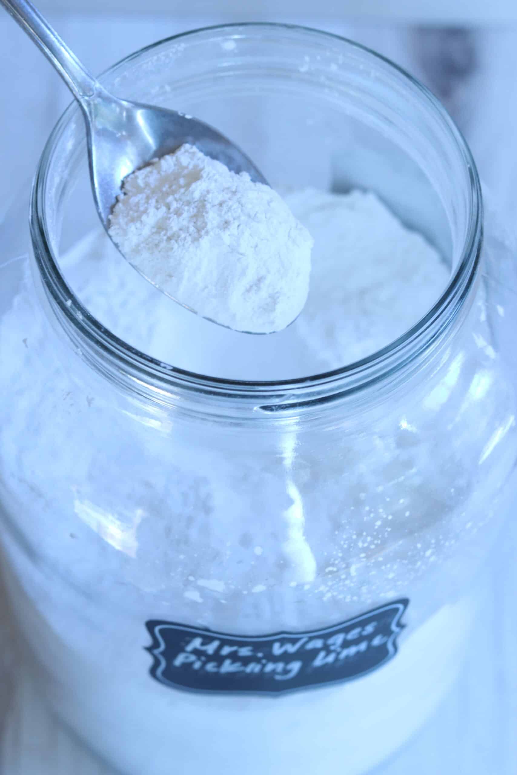 A large clear jar of white pickling lime powdered for water glassing eggs.