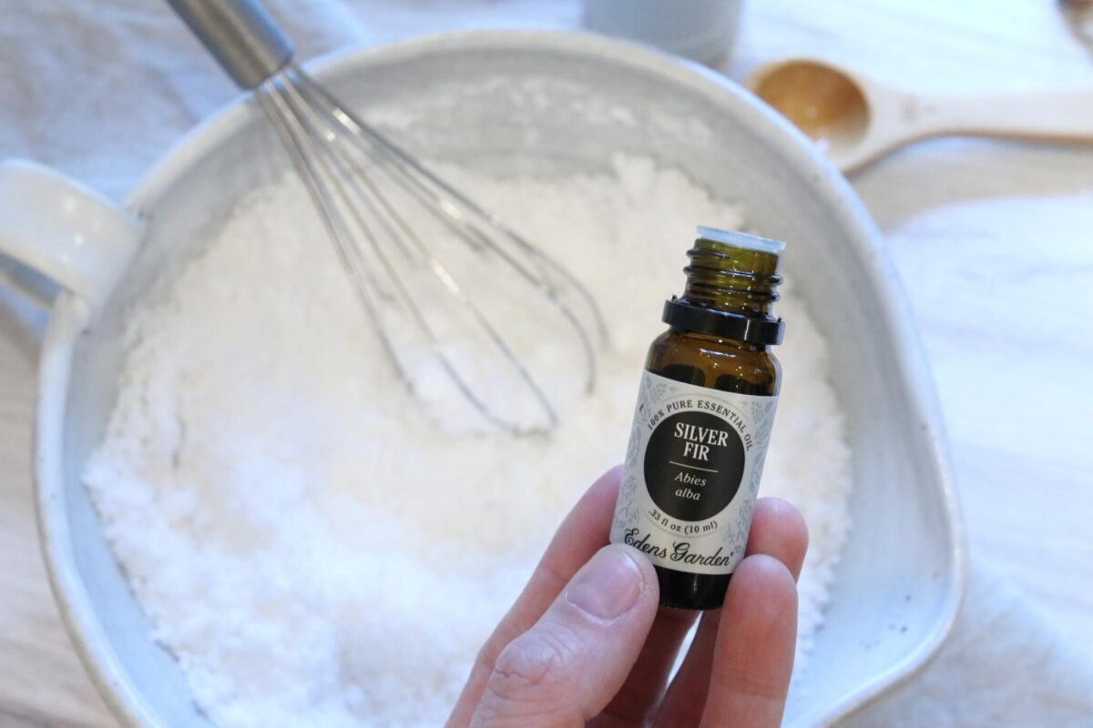 Adding some silver fir essential oil to a batch of citric acid and baking soda to finish off the natural cleaner recipe.