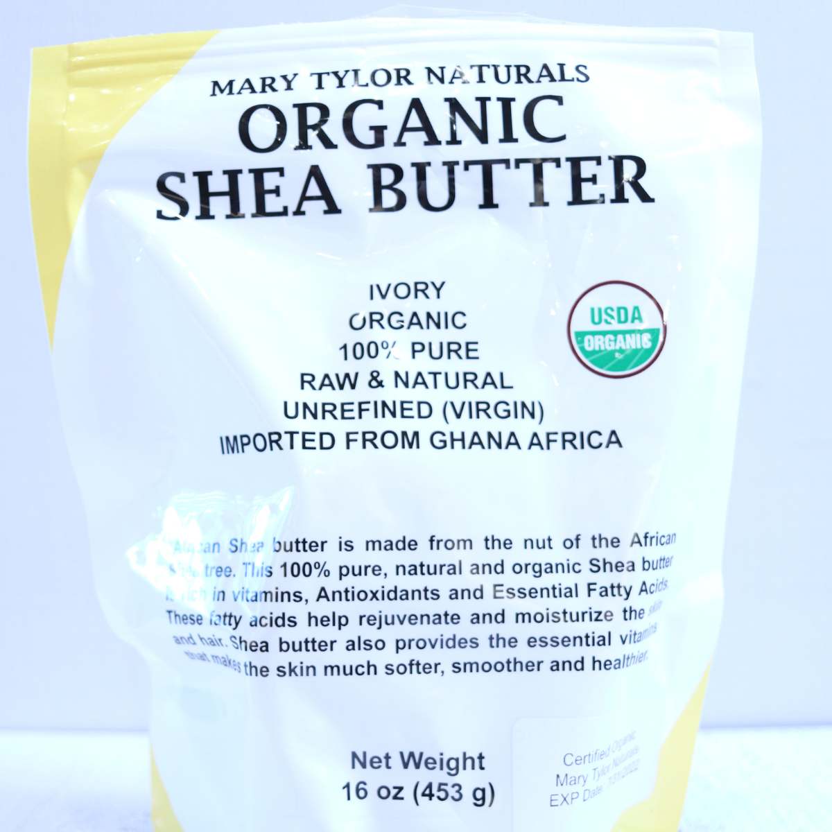 A white and yellow bag of organic shea butter used for making DIY beauty product recipes.