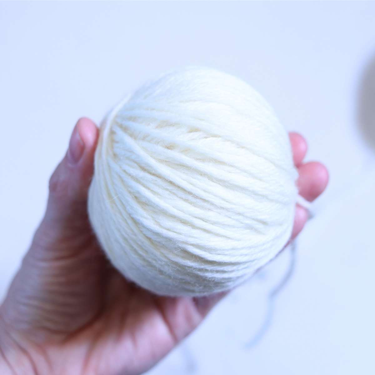 A close up picture of the side of a yarn wool dryer ball. 