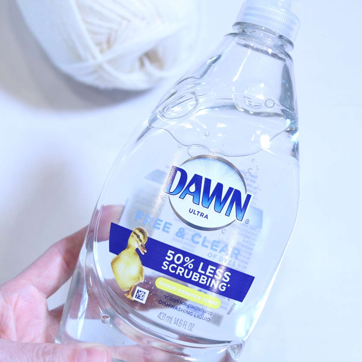 A clear plastic bottle of Dawn free and clear dish soap sometimes used for detergent felting wool. 